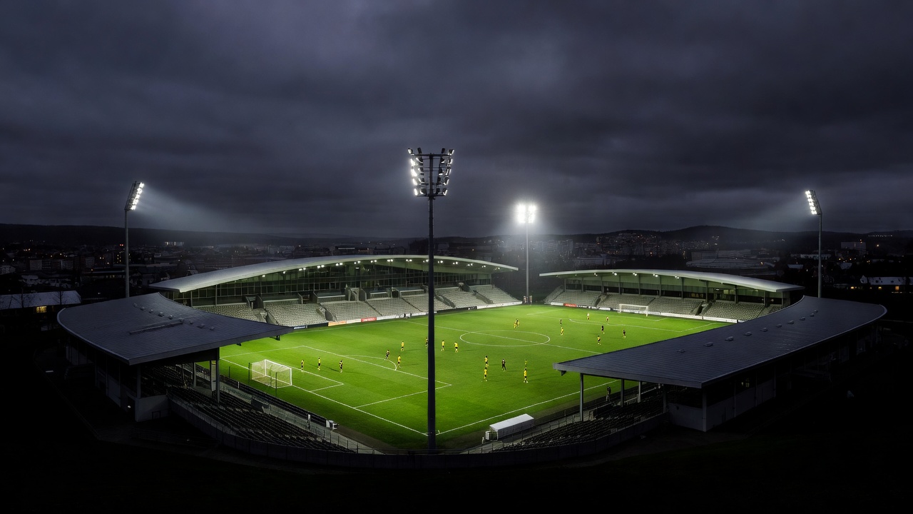 Trondheim football stadium illuminated during a dark Nordic evening